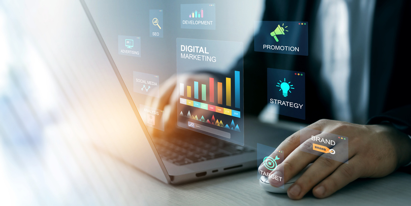 Person using a laptop with holographic digital marketing tools displayed on the scree