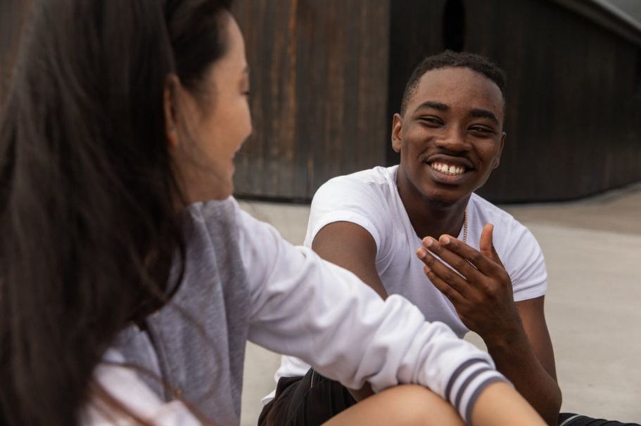 happy-multiethnic-friends-laughing-together-on-city-street