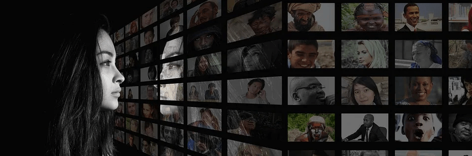 woman looking through a variety of images and her reflection