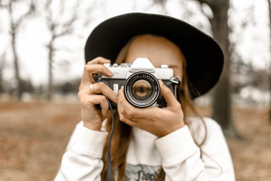 selective-focus-photography-of-woman-using-white-and-black-slr-camera