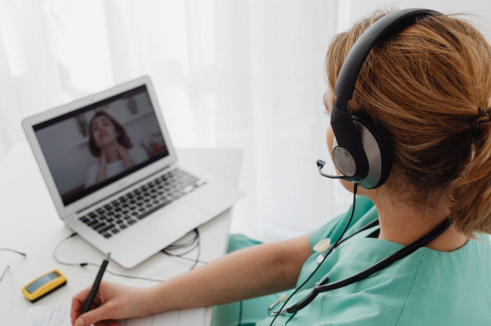 woman-wearing-headphones-while-video-calling-to-patient
