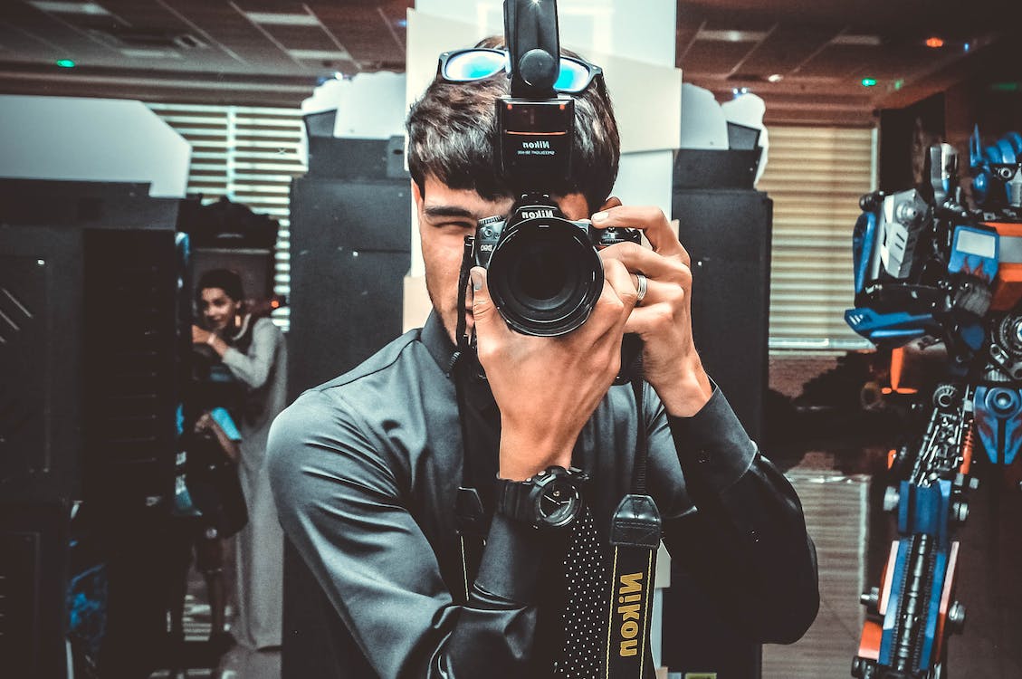 photo of a man using his Nikon camera
